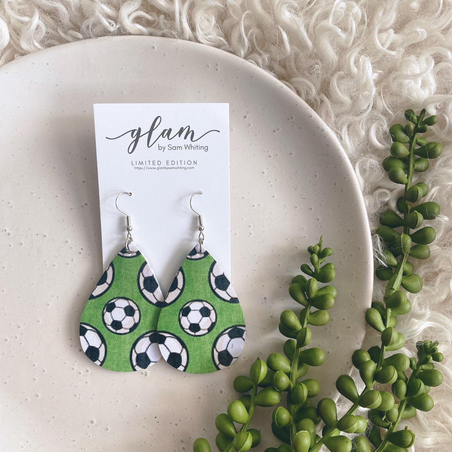 Footy, rugby, football, Soccer or Basketball leather earrings on a silver coloured hook.