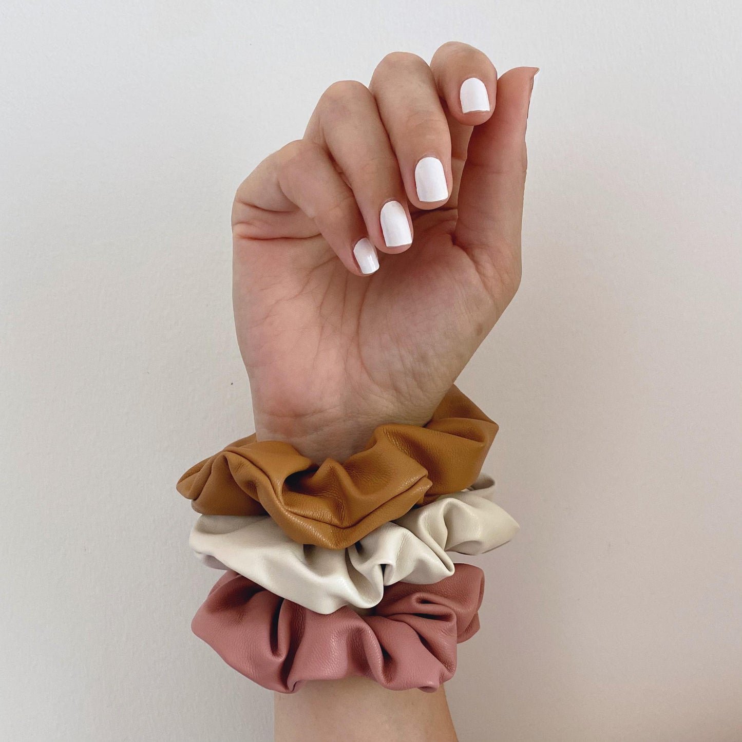 Dusty pink, tan and cream faux leather hair scrunchie on wrist