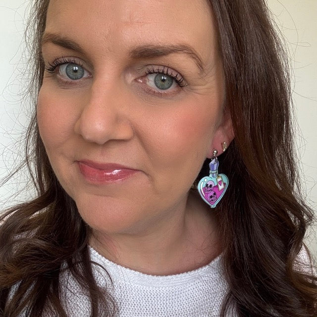 Woman wearing heart-shaped earrings with a white background