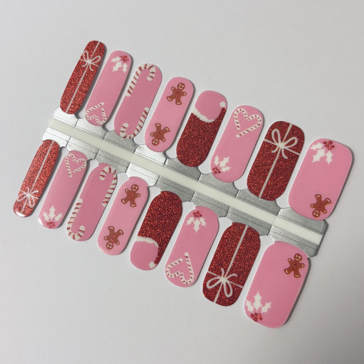 Set of Christmas-themed nail art designs on pink and red backgrounds.