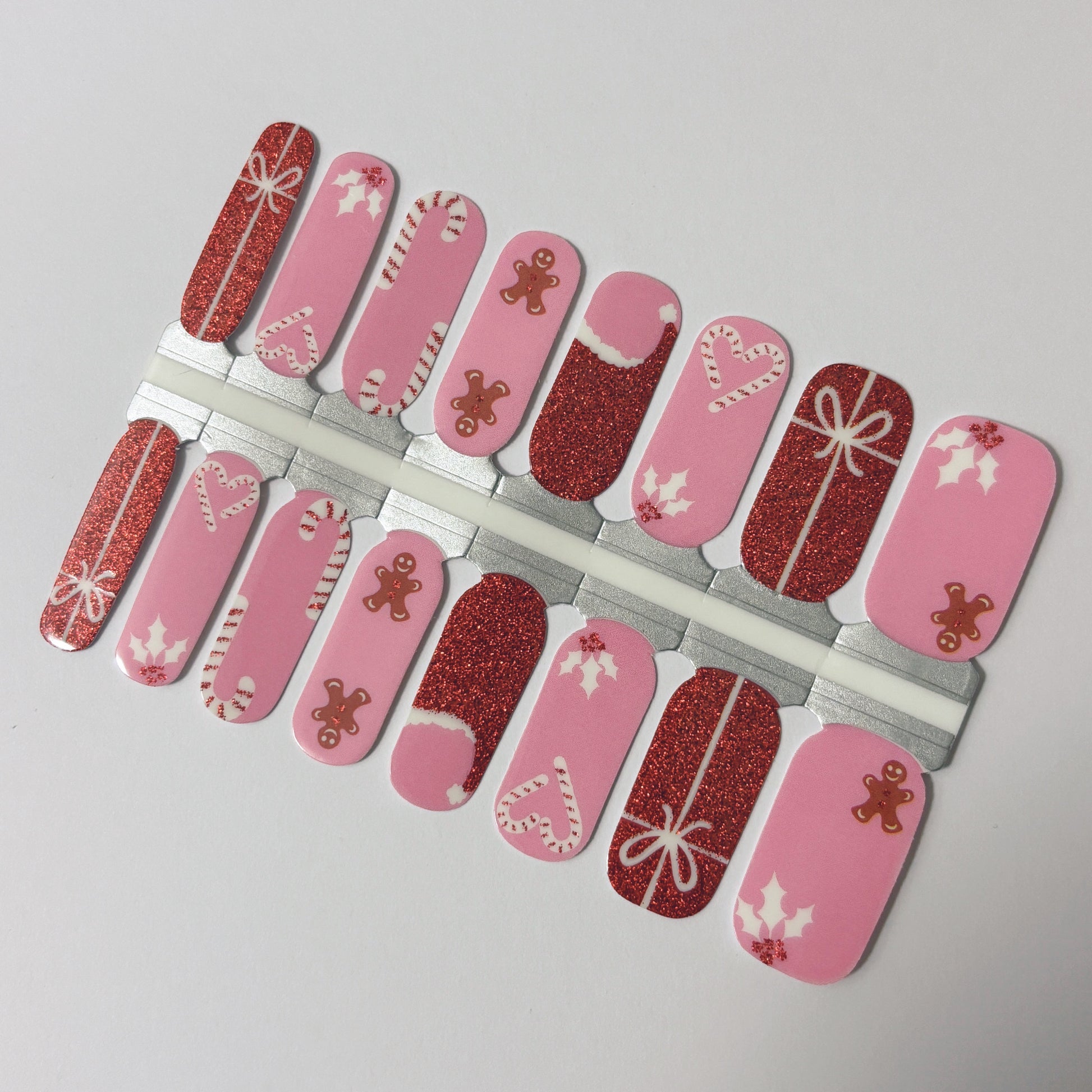 Set of Christmas-themed nail art designs on pink and red backgrounds.