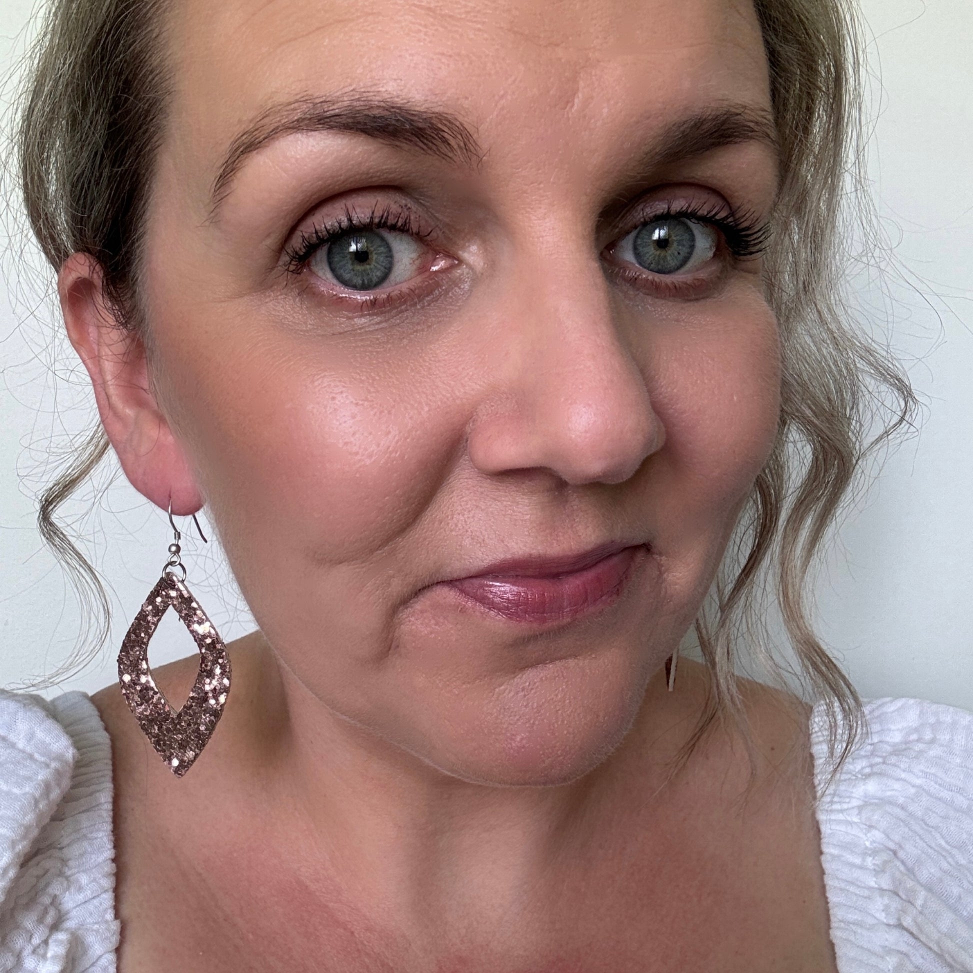 light pink daimond cut out sparkly leather earrings selfie