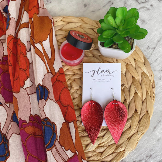 Red metallic petal earrings. Faux leather with silver coloured hooks.