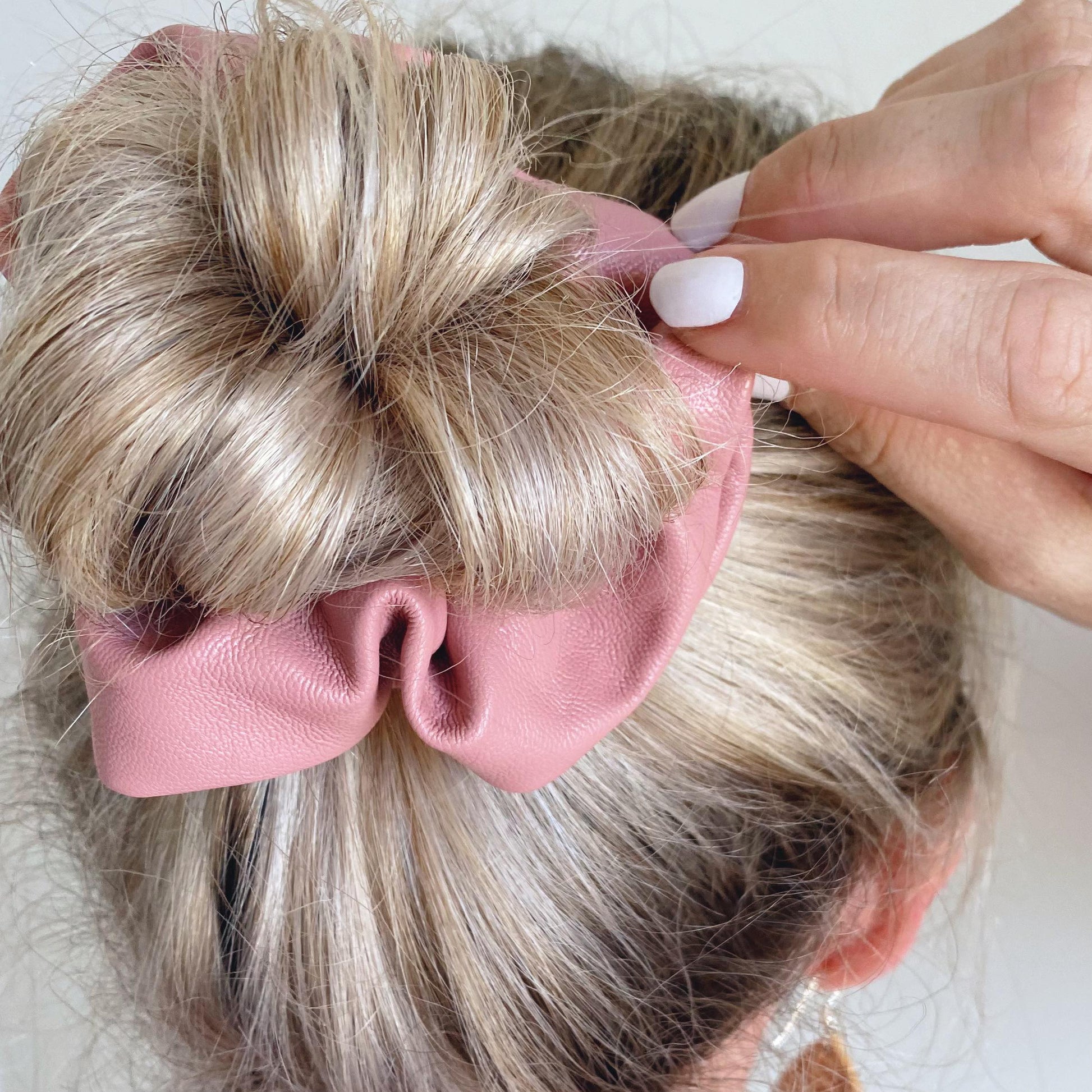 Dusty pink faux leather hair scrunchie around bun