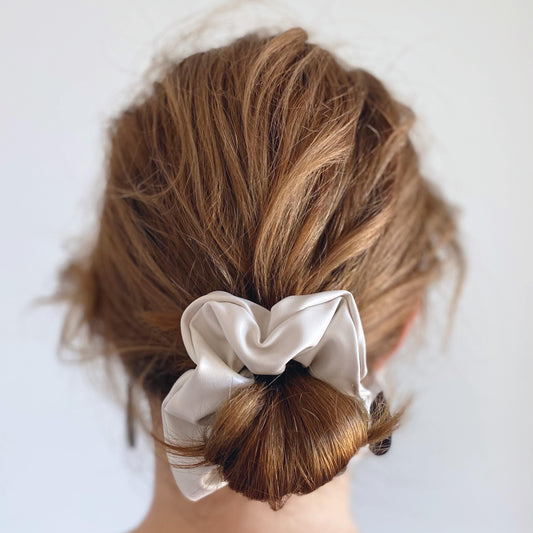 Cream faux leather hair scrunchie in low bun