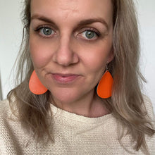 Load image into Gallery viewer, Orange Teardrop leather earrings on a silver coloured hook. 
