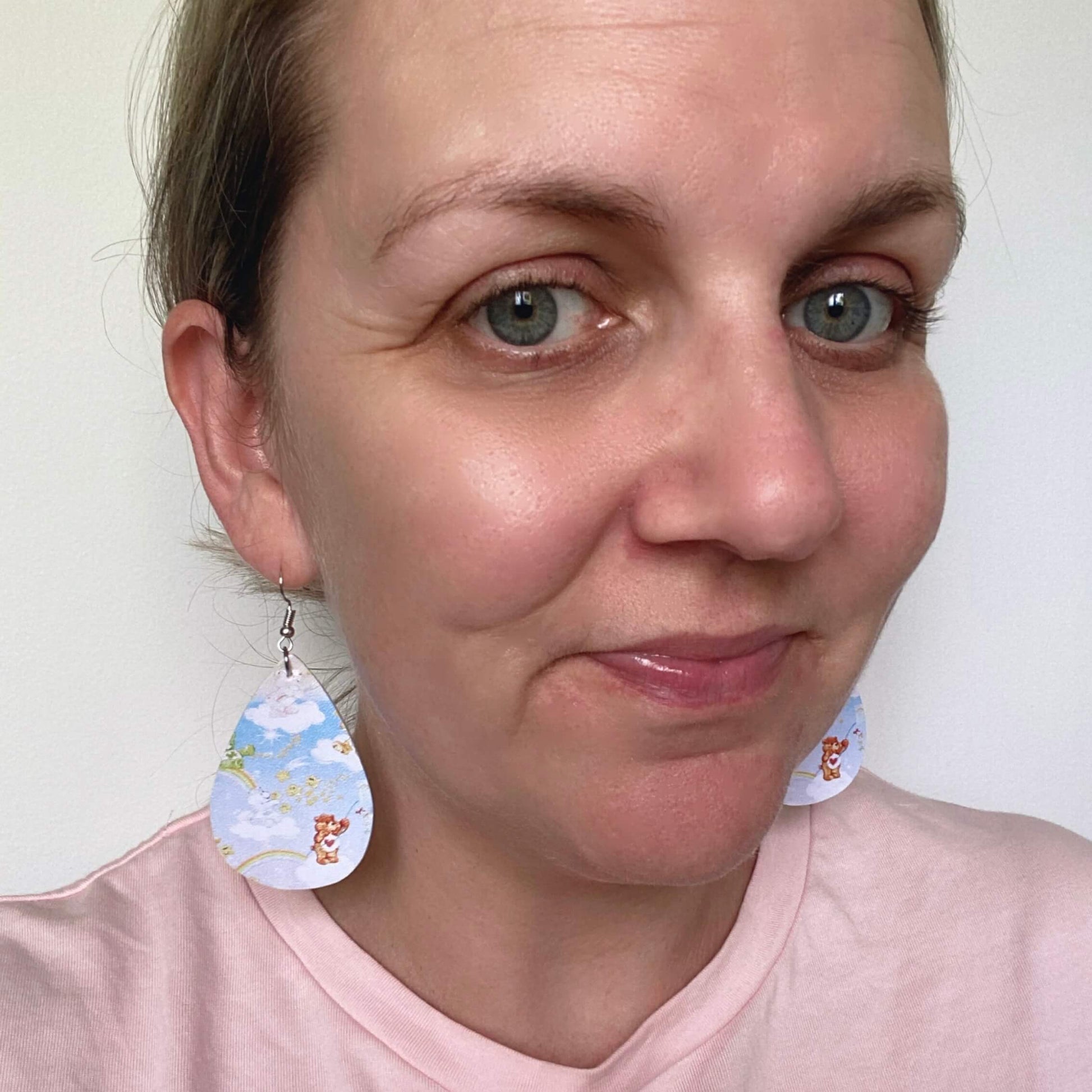 Care Bears inspired leather earrings with a silver coloured hook. 