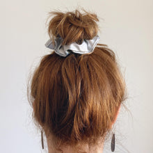Load image into Gallery viewer, Silver faux leather hair scrunchie in a top knot

