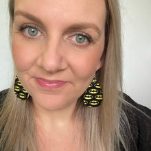 Load image into Gallery viewer, Batman inspired leather earrings with a silver coloured hook.
