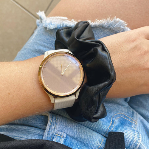 Black faux leather hair scrunchie on wrist