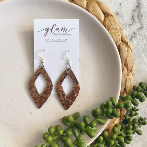 Coffee Diamond cut out leather earrings on a silver coloured hook.
