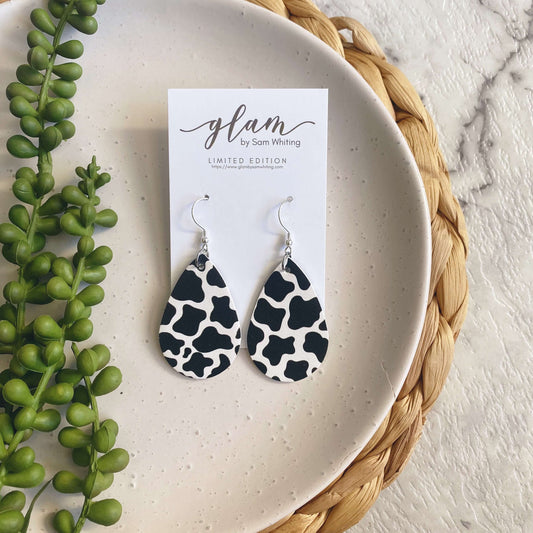 Cow print mini leather earrings on a silver coloured hook.  