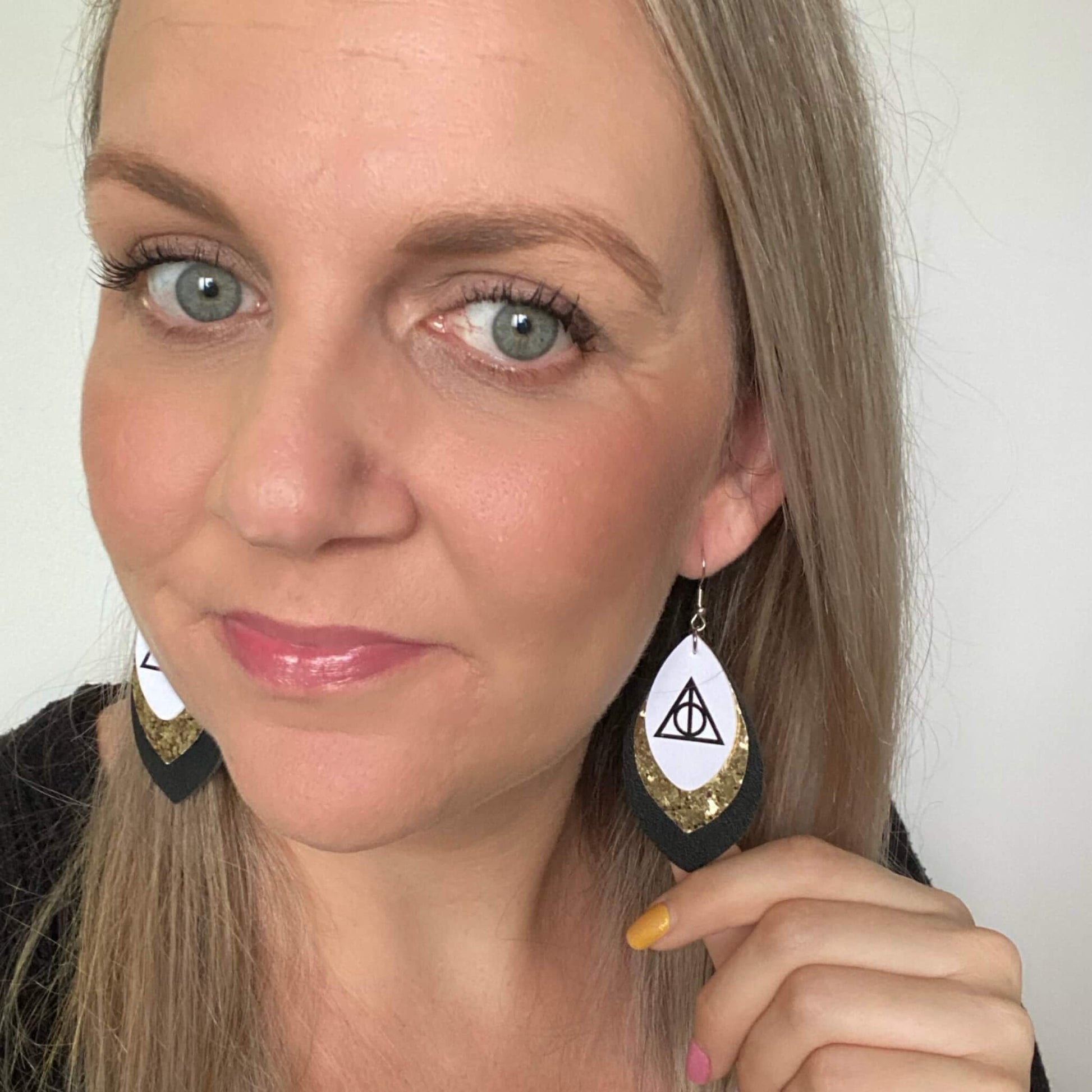 Harry Potter Deathly Hallows inspired leather earrings with a silver coloured hook. 