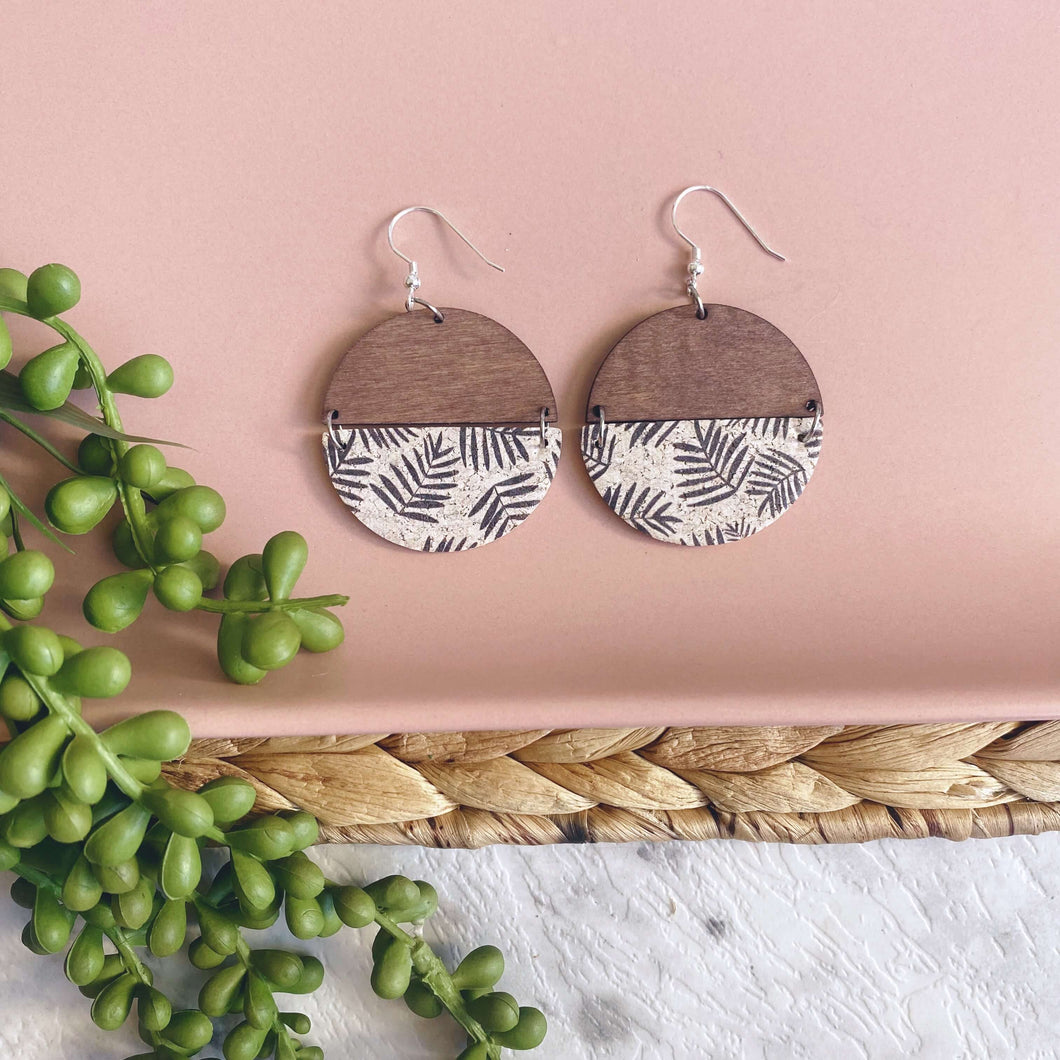 Frond and timber semi circles on a silver coloured hook. 