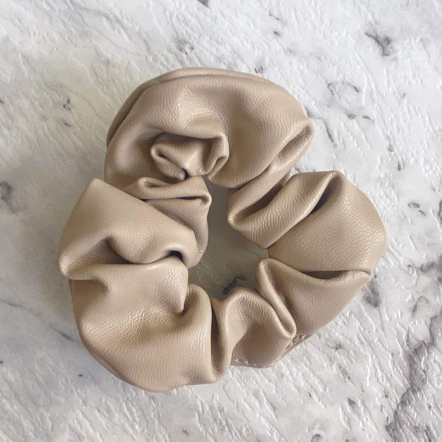 Latte faux leather hair scrunchie perfect for all hair types that compliments any style.