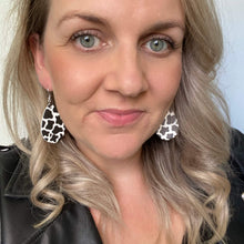 Load image into Gallery viewer, Cow print mini leather earrings on a silver coloured hook.  

