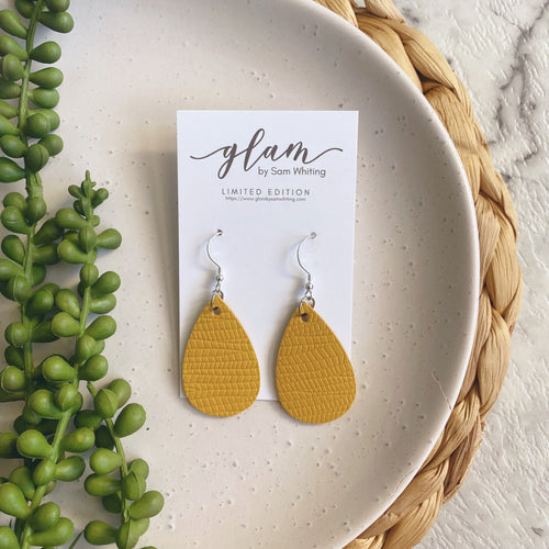 Mustard embossed mini leather earrings on a silver coloured hook. 