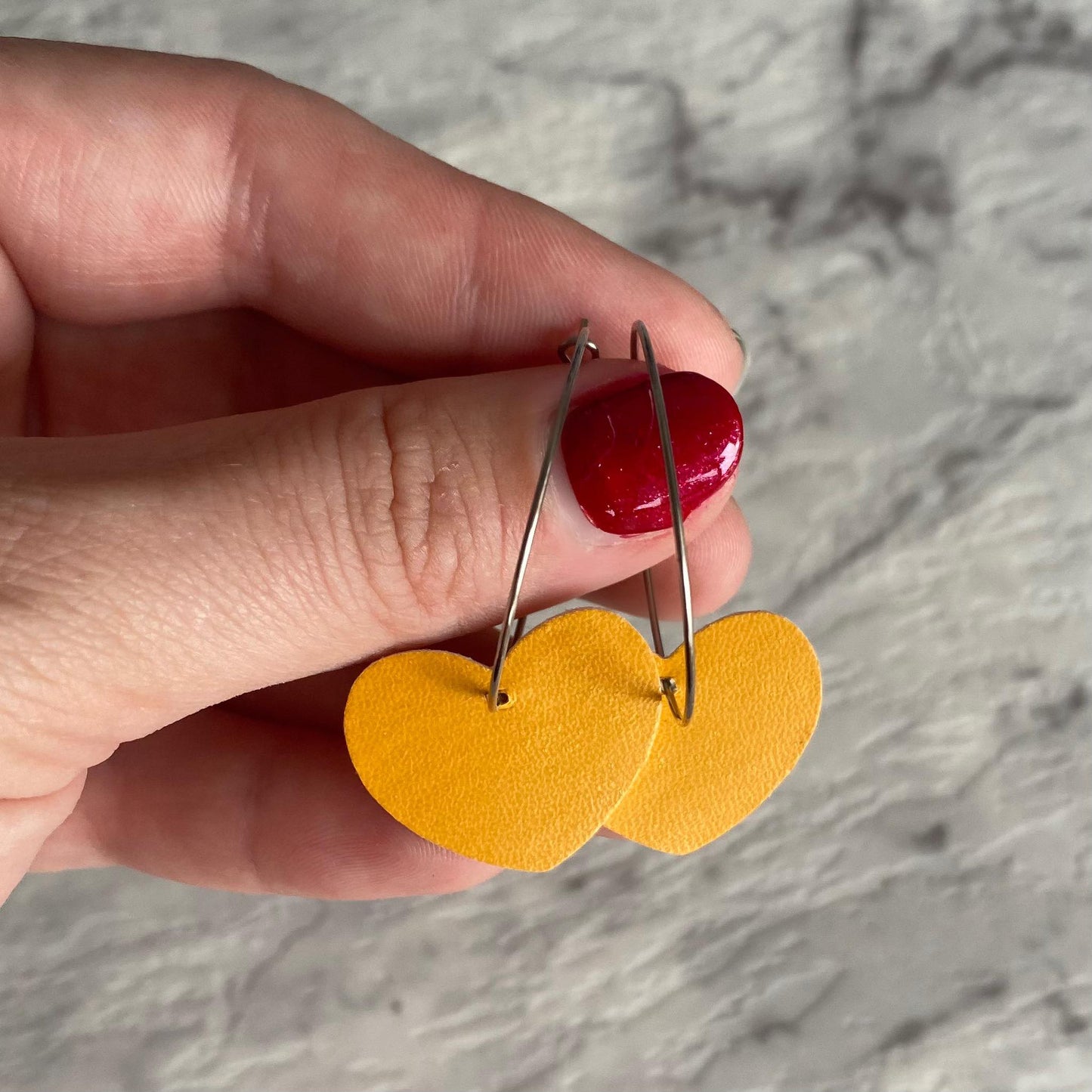 mustard Heart hoop earrings. Faux leather with silver coloured hoops.