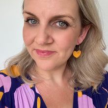 Load image into Gallery viewer, Heart hoop leather earrings. Faux leather with silver coloured hoops. mustard yellow 
