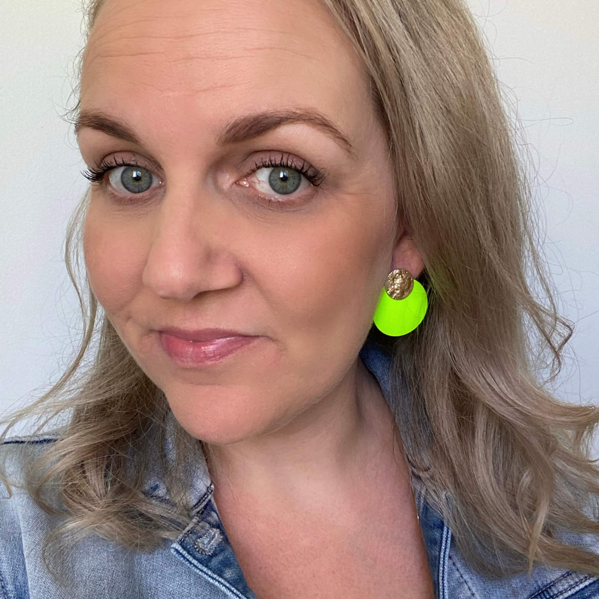 neon green Leather circle studs. selfie