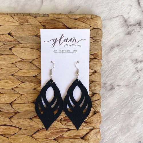 Black ornate cut out leather earrings with a silver coloured hook.