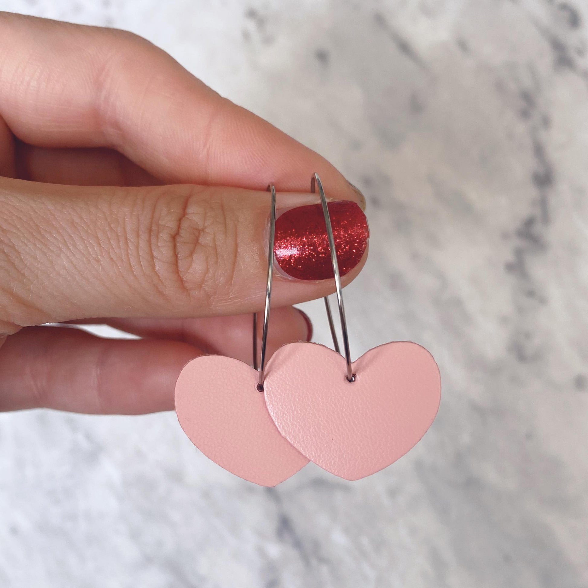 Pink heart hoop earrings. Faux leather with silver coloured hoops.