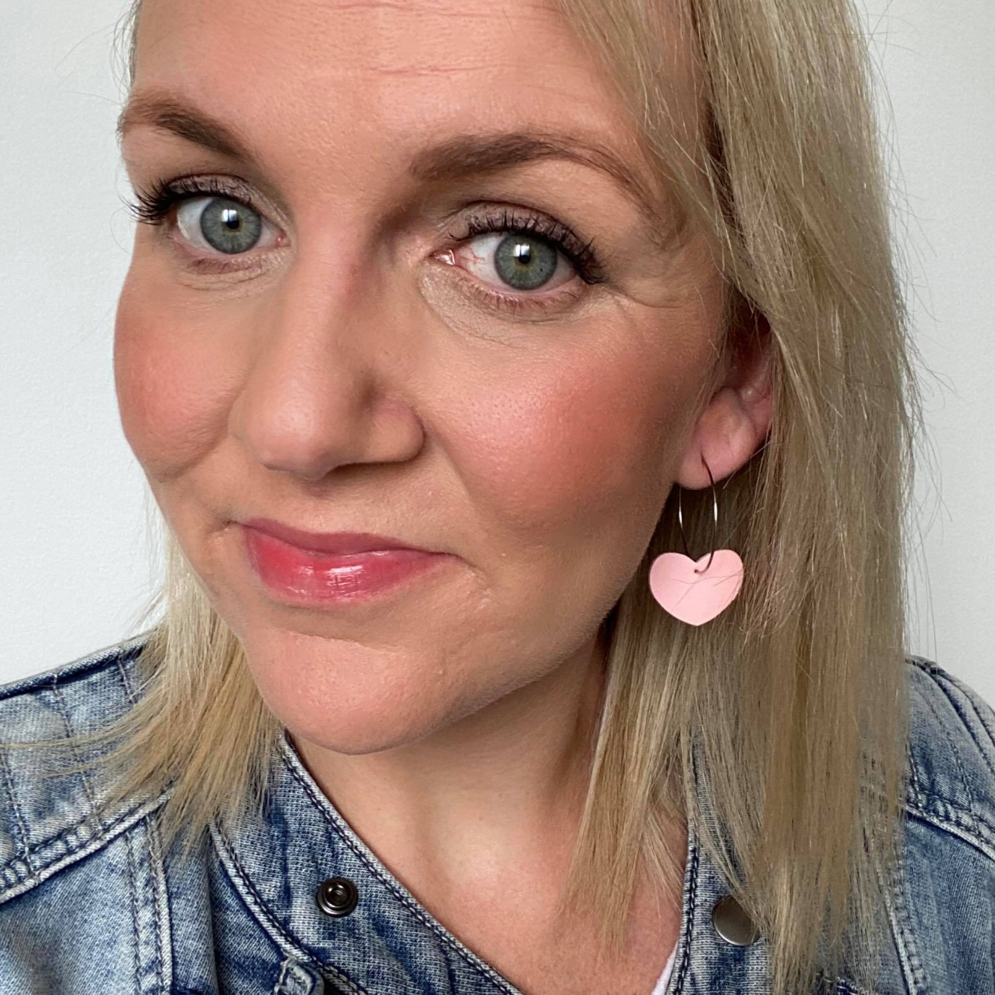 Pink heart hoop earrings selfie. Faux leather with silver coloured hoops.
