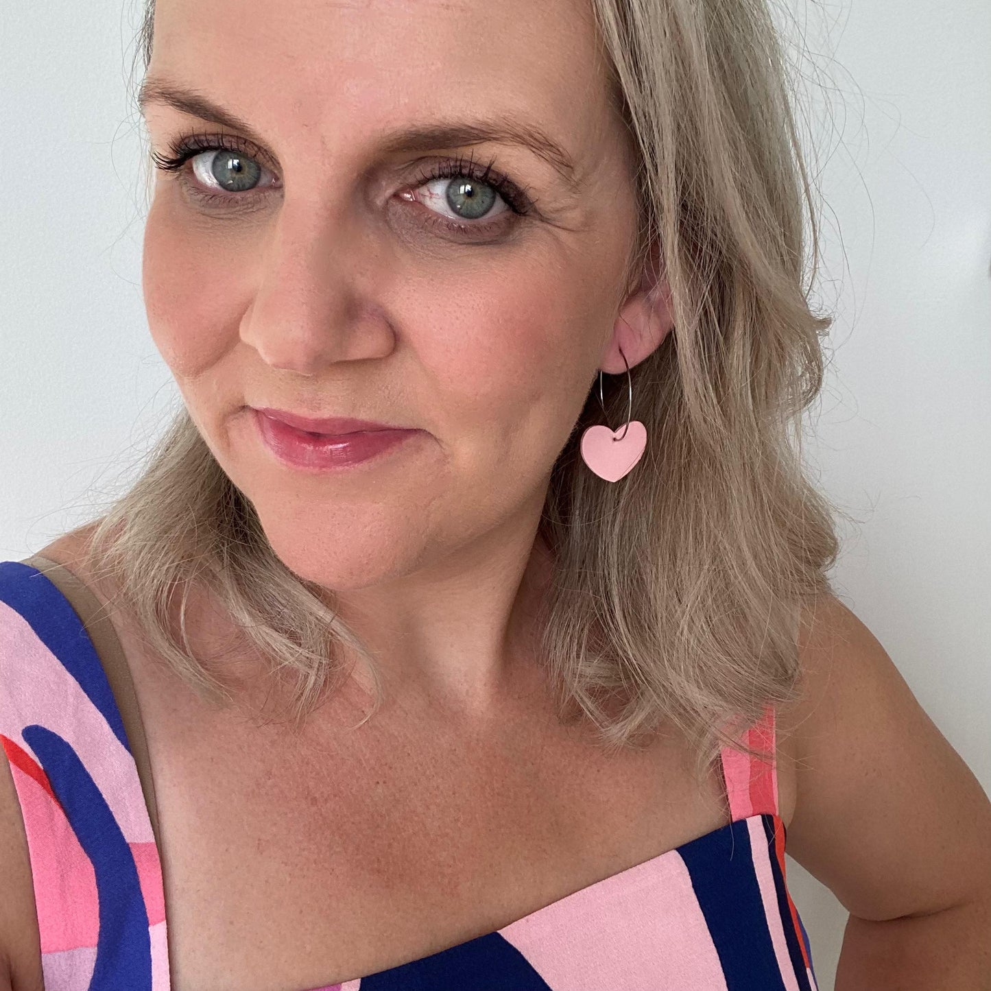pink Heart hoop leather earrings. Faux leather with silver coloured hoops.