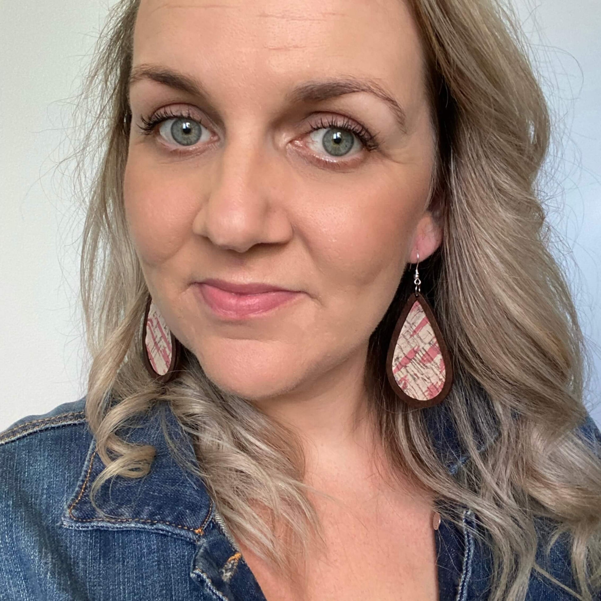 Framed Abstract pink leather earrings with a silver coloured hook. 