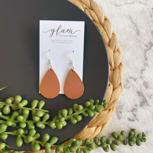 Tan mini teardrop leather earrings with a silver coloured hook. 