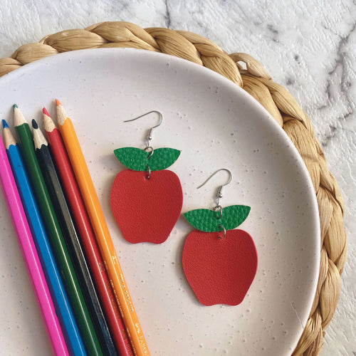 Teacher appreciation christmas gift Apple cut out leather earrings on a silver coloured hook.