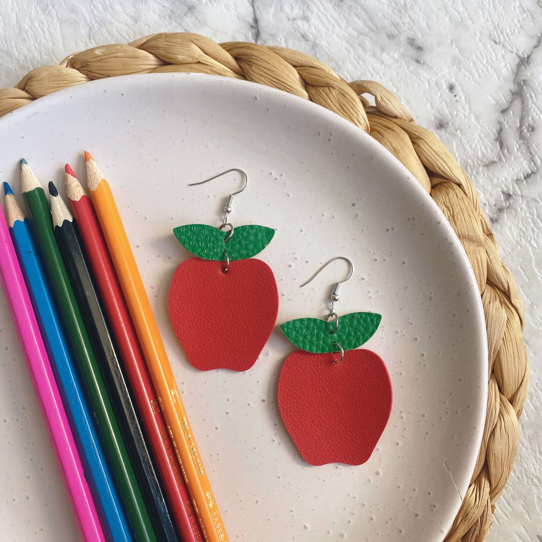 Teacher appreciation christmas gift Apple cut out leather earrings on a silver coloured hook.