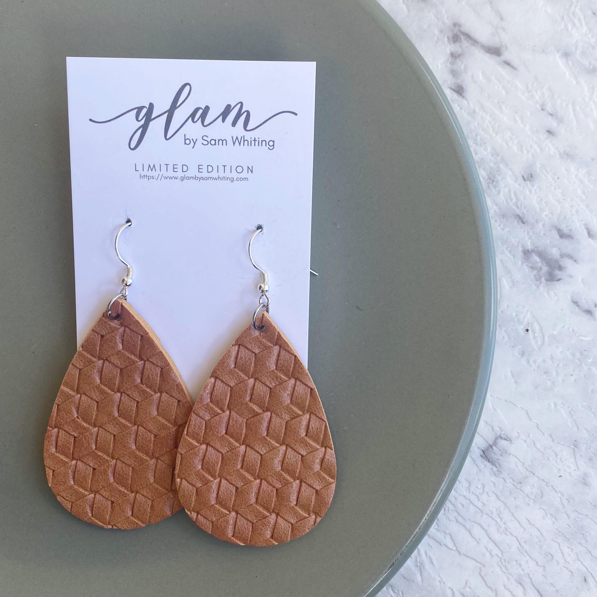 Textured tan teardrops.  Leather earrings with silver coloured hook.