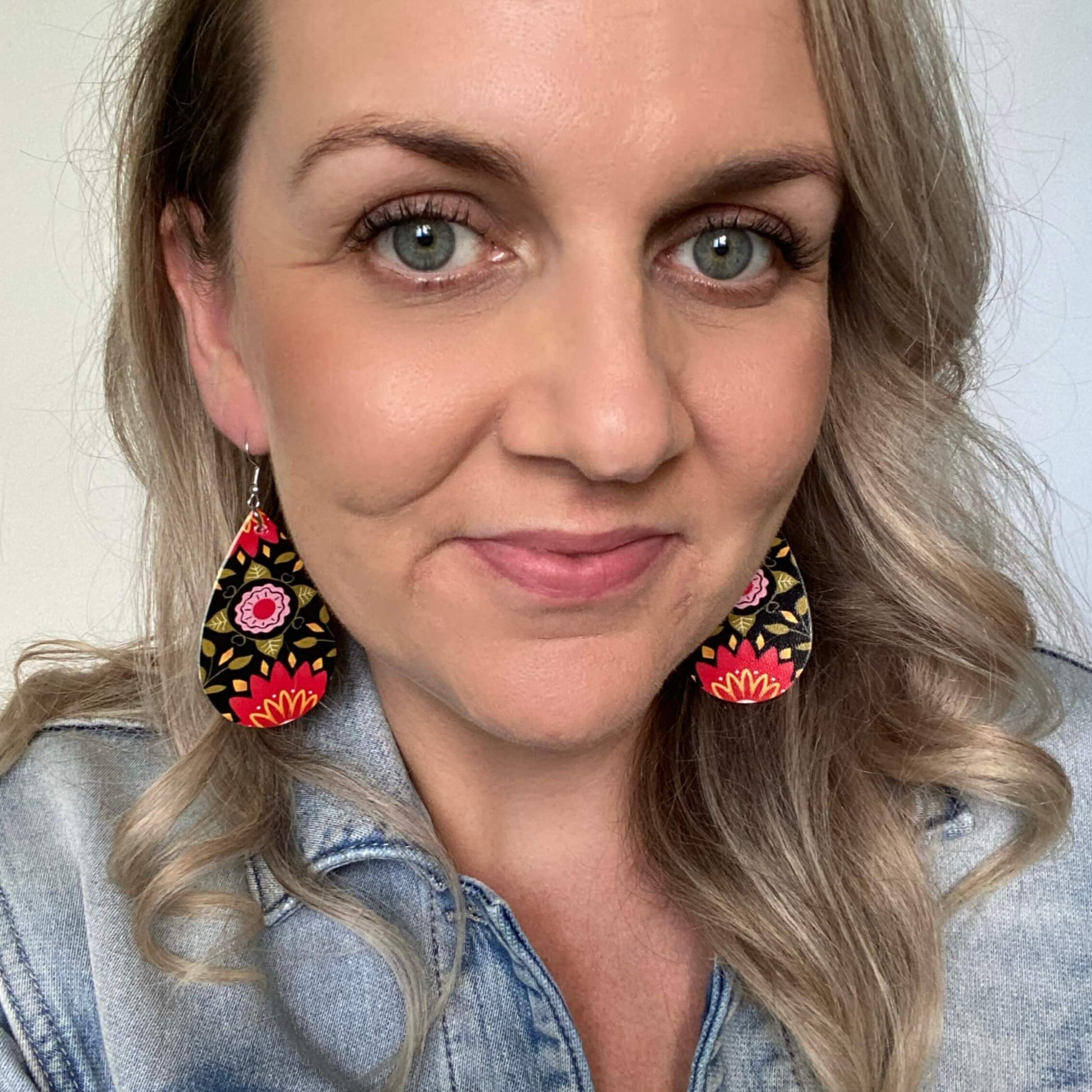 Mandala teardrop shaped leather earrings on a silver coloured hook. 