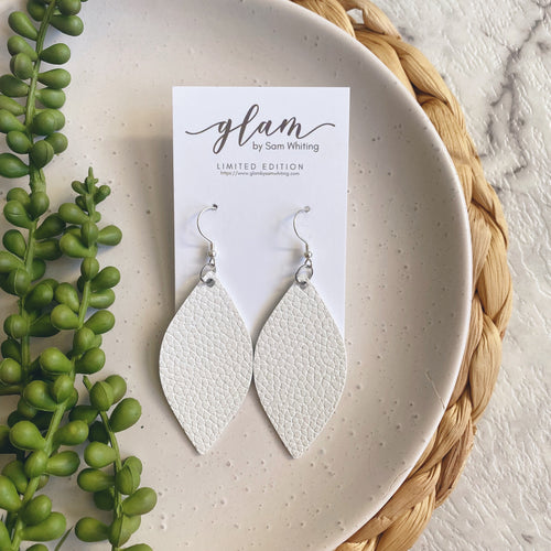 White leaf leather earrings on a silver coloured hook. 
